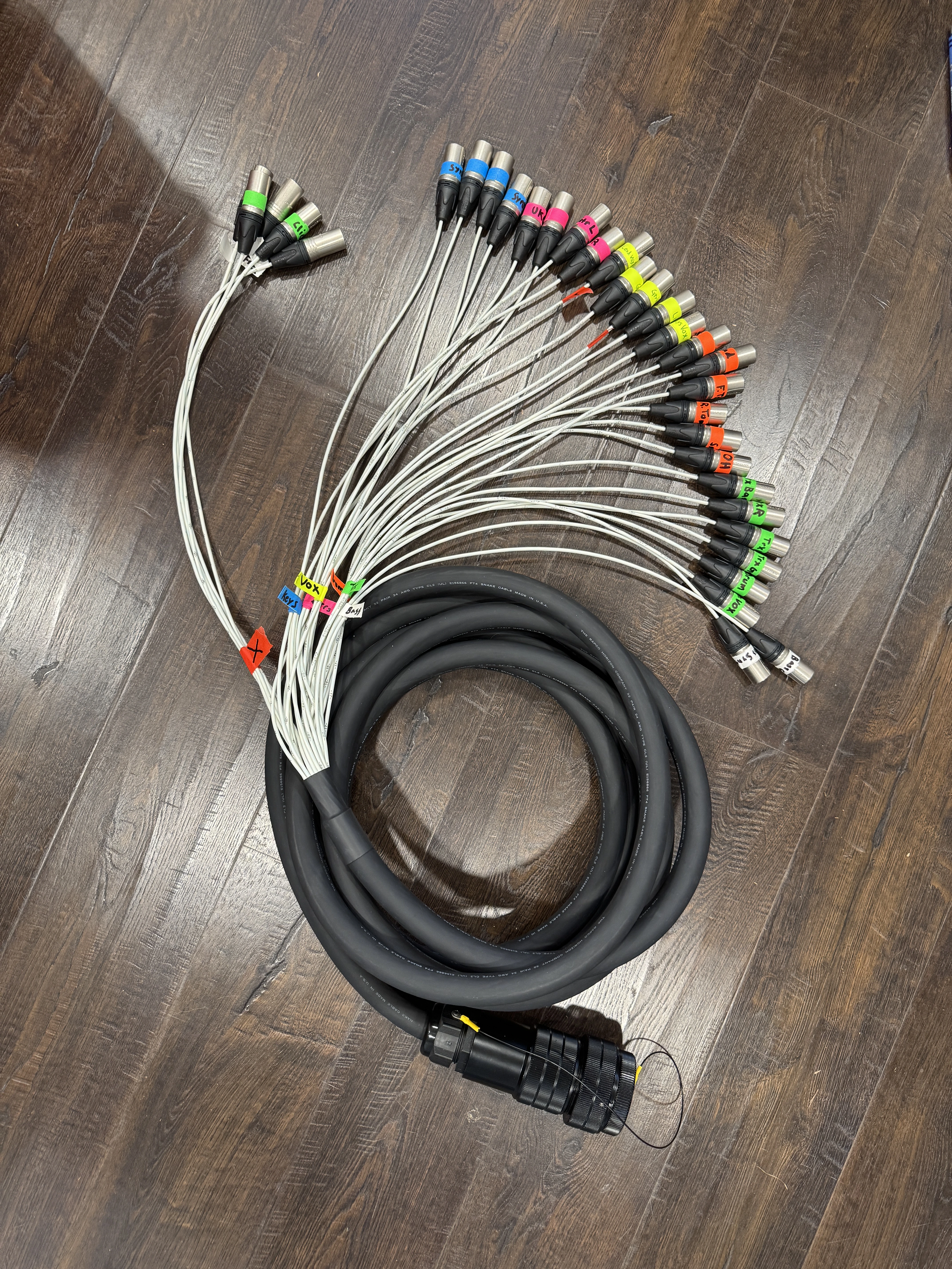 32-channel fan-out cable spread out — color-coded XLR ends, individually numbered